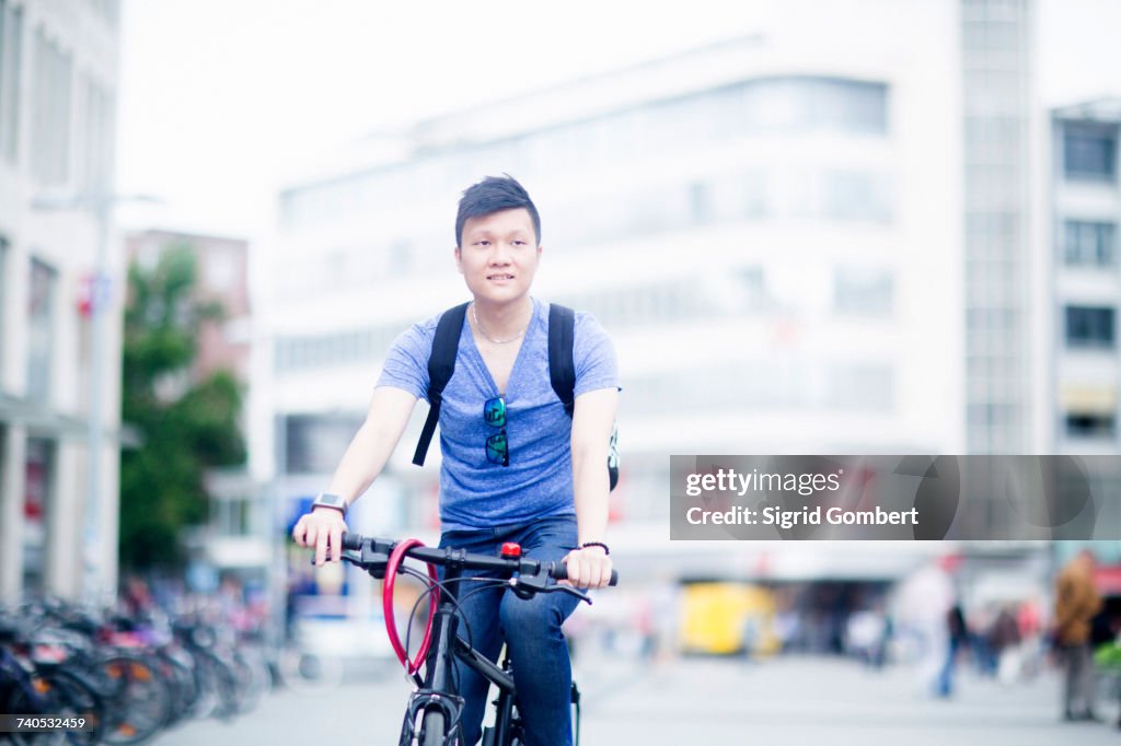 Man riding bicycle in city