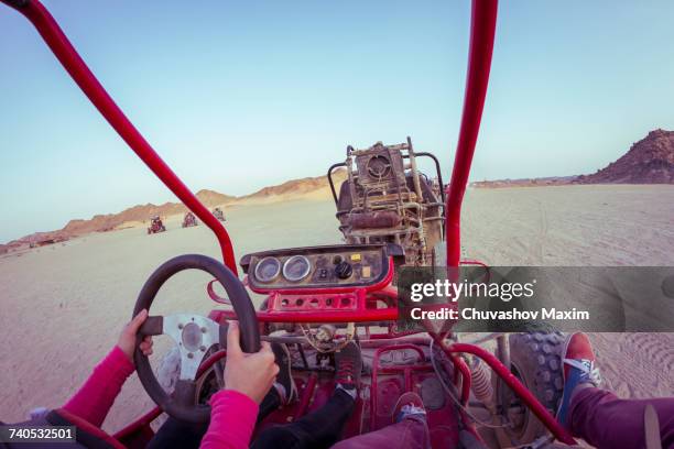 personal perspective view of two people driving beach buggy in desert, hurghada, al bahr al ahmar, egypt - dune buggy stock pictures, royalty-free photos & images