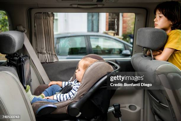 baby and big brother watching movie in car - looking backwards stock pictures, royalty-free photos & images