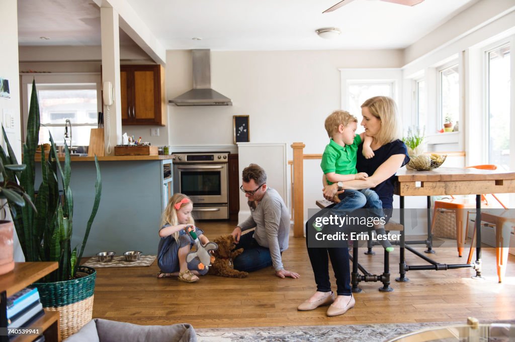Parents in kitchen together with son and daughter