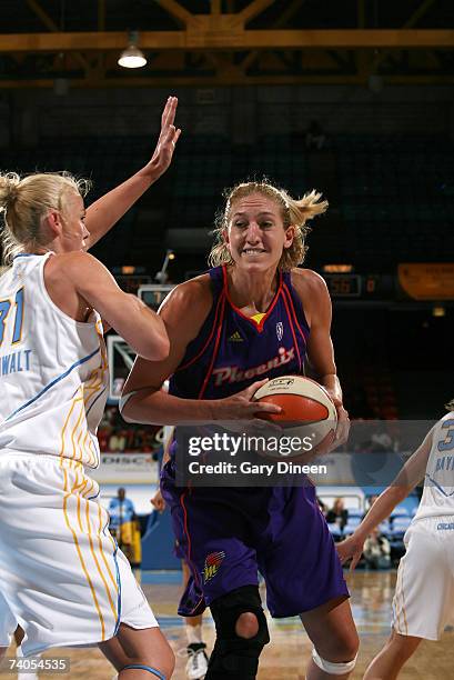 Kelly Schumacher of the Phoenix Mercury looks to pass while guarded by Cisti Greenwalt of the Chicago Sky during the WNBA preseason game on May 2,...