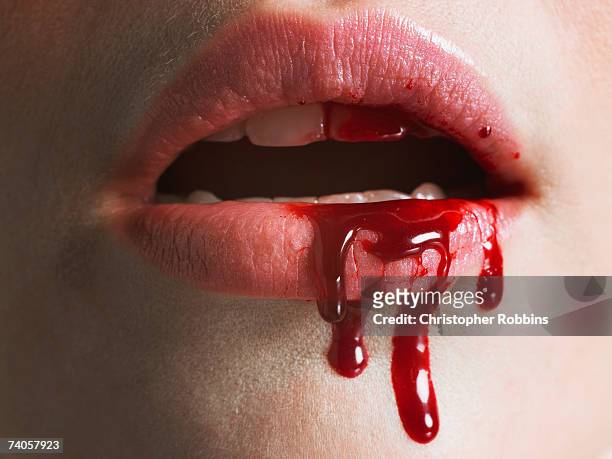 young woman with blood on mouth, close-up of lips - blut stock-fotos und bilder