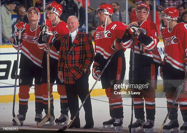 Canadian ice hockey commentator and coach Don Cherry smiles on the ice with members of Team Cherry, whom he coached to victory in the Top Prospects...
