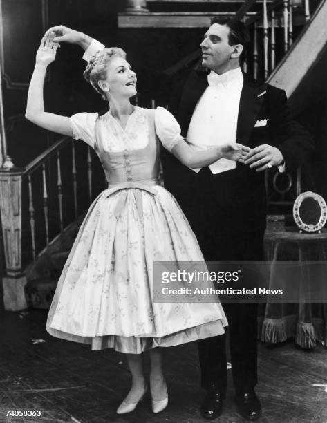 American actress Mary Martin dances with Austrian actor Theodore Bikel in a scene from the musical 'The Sound of Music' at the Lunt-Fontanne Theatre,...