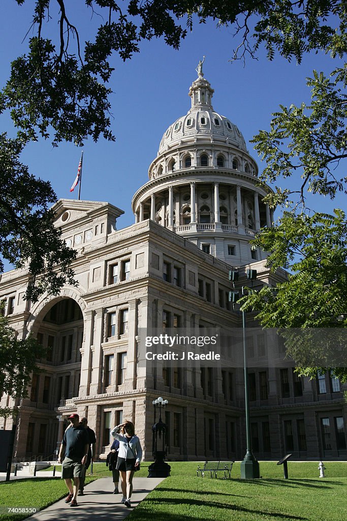 Visitors walk away from the Texas Capital Building in Austin, Texas, USA