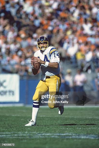 Quarterback Dan Fouts of the San Diego Chargers rolls out during the game against the Denver Broncos at Mile High Stadium on September 27, 1981 in...