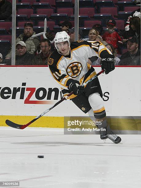 Brandon Bochenski of the Boston Bruins moves the puck against the New Jersey Devils at Continental Airlines Arena on April 1, 2007 in East...