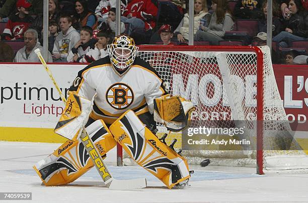 Tim Thomas of the Boston Bruins eyes the puck against the New Jersey Devils at Continental Airlines Arena on April 1, 2007 in East Rutherford, New...