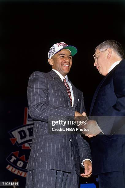 Damon Stoudamire drafted by the Toronto Raptors shakes NBA Commissioner David Stern's hand during the 1995 NBA Draft on June 28, 1995 at the Toronto...