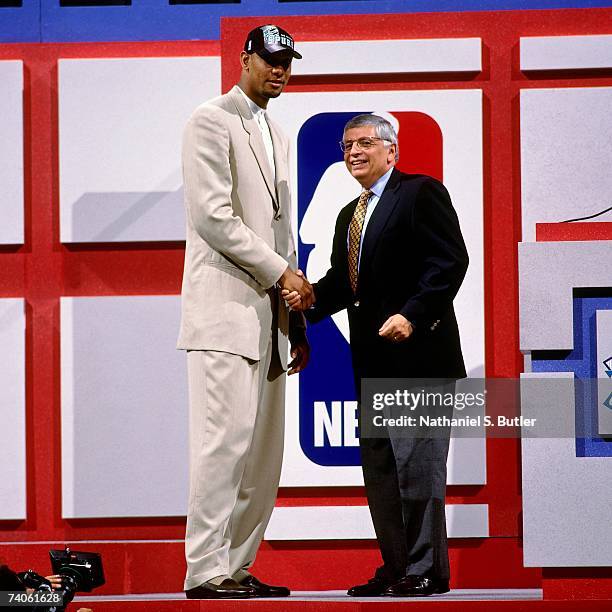 Tim Duncan taken number one overall by the San Antonio Spurs shakes NBA Commissioner David Stern's hand during the 1997 NBA Draft on June 25, 1997 at...