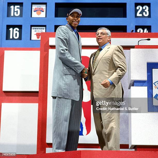 Shawn Marion drafted by the Phoenix Suns shakes NBA Commissioner David Stern's hand during the 1999 NBA Draft on June 30, 1999 at the MCI Center in...