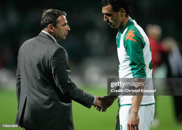 Manager Klaus Allofs of Bremen comforts Hugo Almeida of Bremen after their side lost 1-2 the UEFA Cup Semi-Final, second Leg match between Werder...