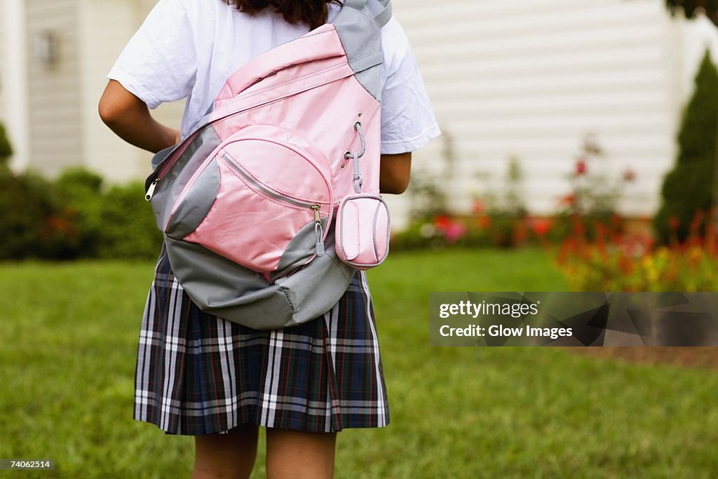 Rear view of a schoolgirl carrying a schoolbag