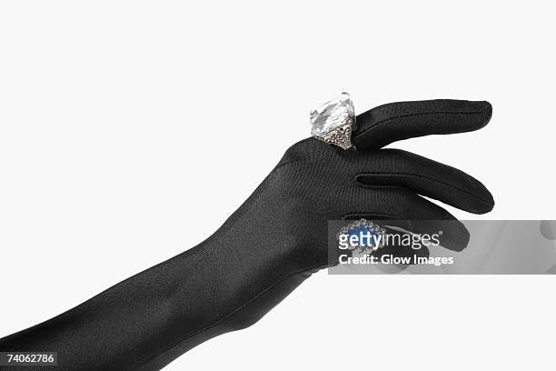 close-up of a person's hand with two rings - evening glove ストックフォトと画像