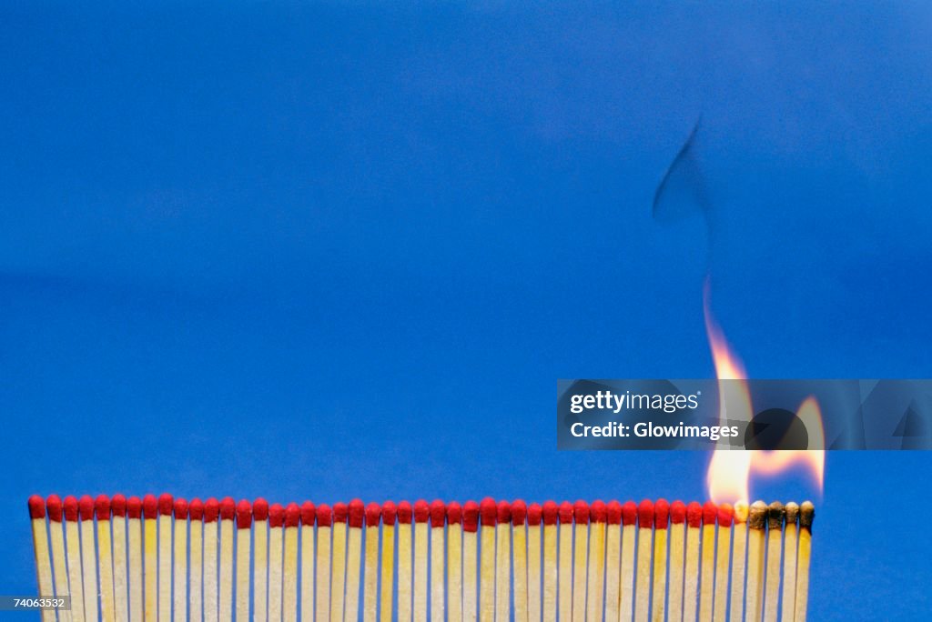 Close-up of matchsticks burning