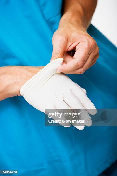 Removing Hand 276 Surgeon Taking Off Gloves Stock Photos, High-Res Pictures, and ...
