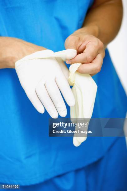 Removing Hand 276 Surgeon Taking Off Gloves Stock Photos, High-Res Pictures, and ...