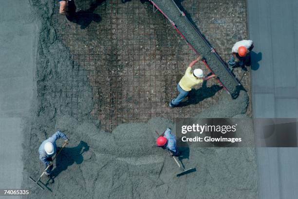 laying cement for road construction - cimento imagens e fotografias de stock