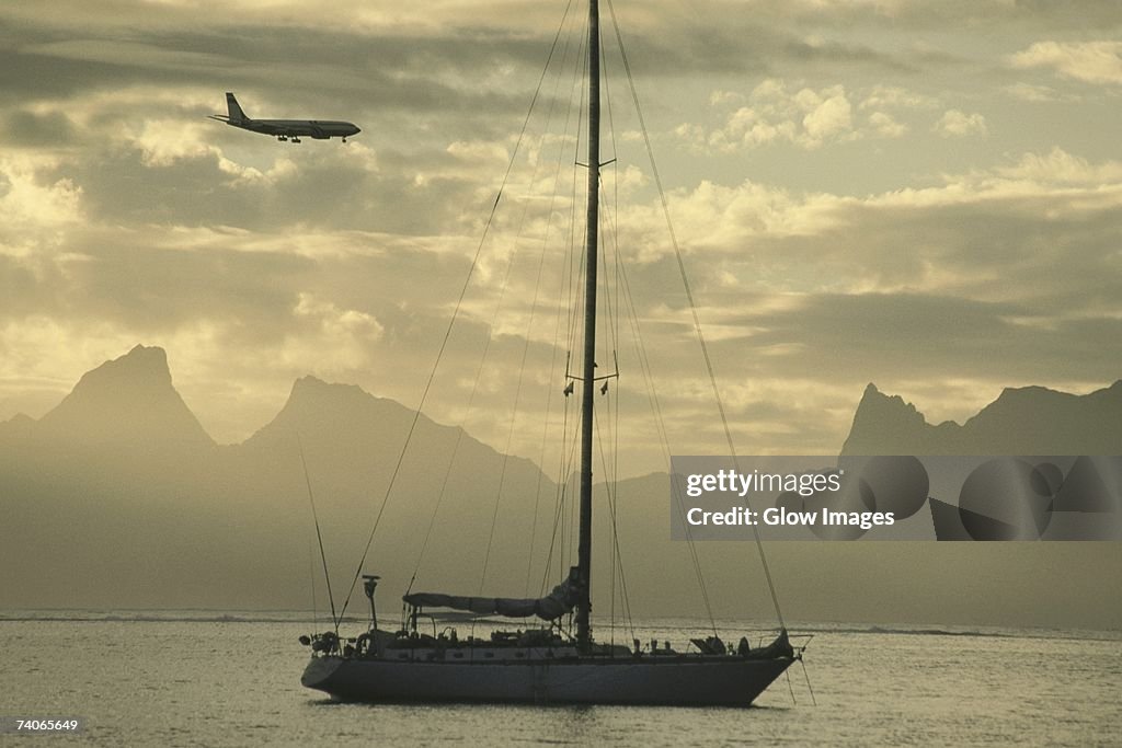 Airplane flying over a sailboat, Moorea, Tahiti, Society Islands, French Polynesia