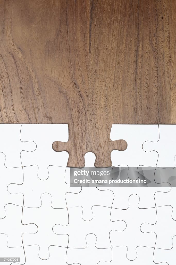 Jigsaw puzzle on wooden background, piece missing