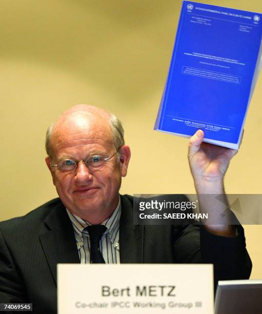 Bert Metz, co-chairman of Intergovernmental Panel on Climate Change Working Group III displays a meeting report during a press conference at the...