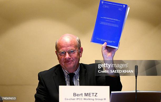 Bert Metz, co-Chairman of Intergovernmental Panel on Climate Change Working Group III displays a meeting report during a press conference at the...