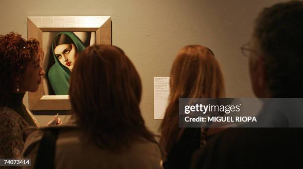 Visitors admire a painting of Tamara de Lempicka during an exhibition 04 May 2007 in Vigo. Lempicka, Born in 1898 to a Polish mother and a wealthy...