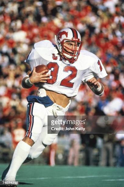 Craig James of Southern Methodist University runs with the ball against BYU during the 1980 Holiday Bowl .