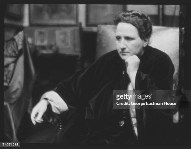 Portrait of American author Gertrude Stein as she sits in an armchair, 1913.
