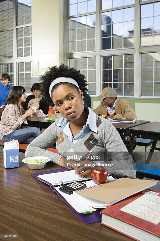 Girl working by herself in cafeteria