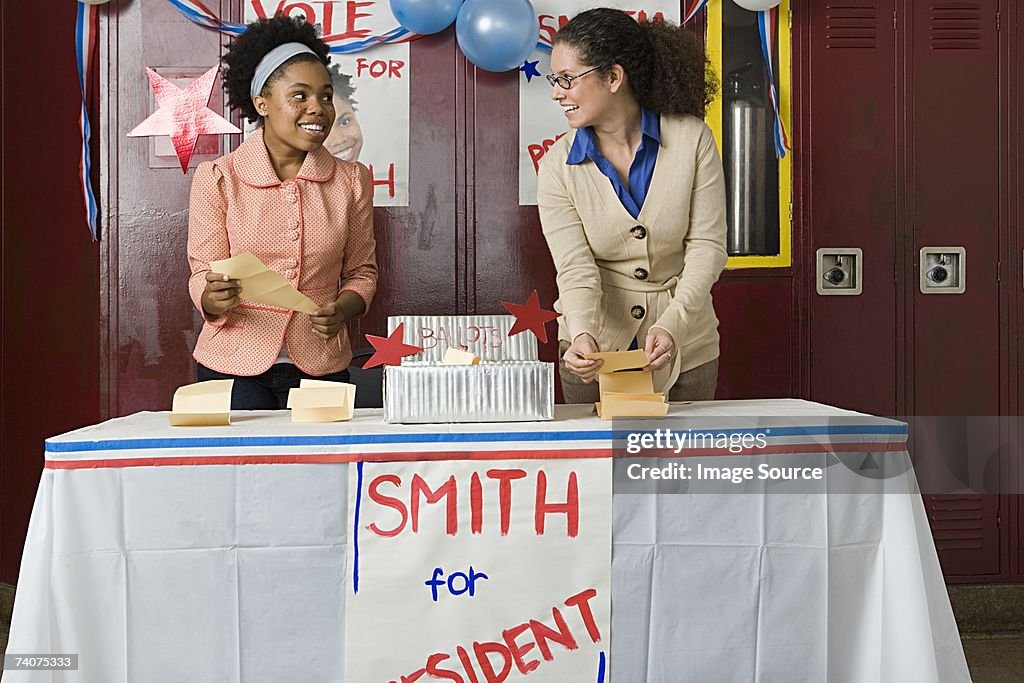 Girl and teacher counting votes
