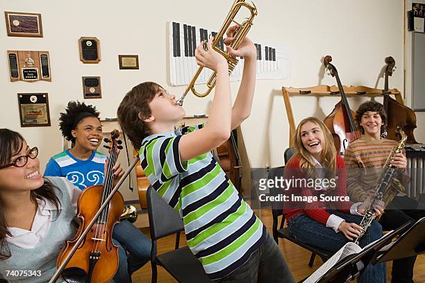 boy playing trumpet - boy band stockfoto's en -beelden