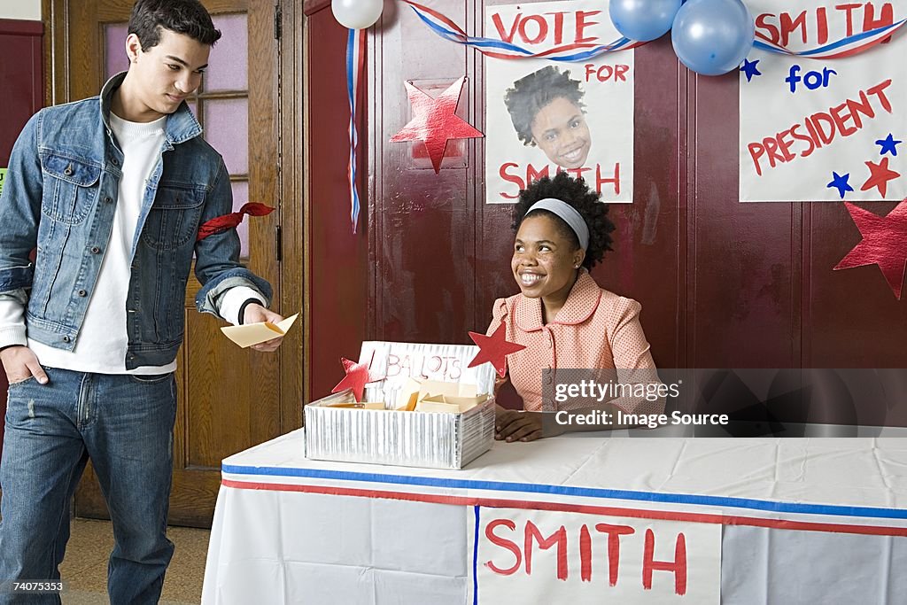Boy giving his vote to girl