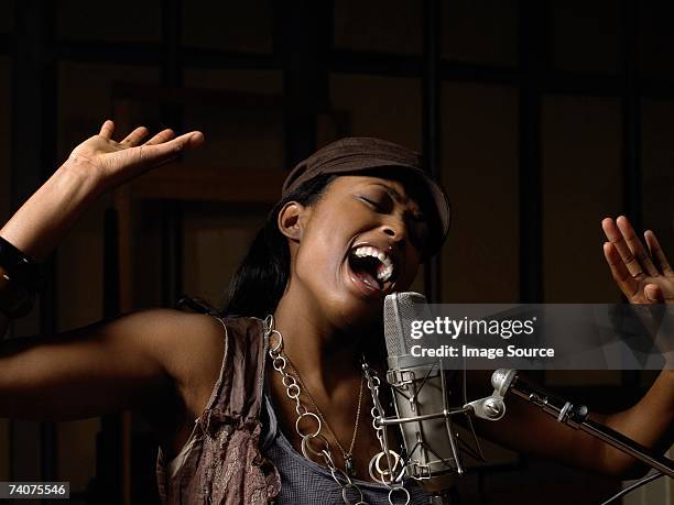 young woman singing - singer microphone stock pictures, royalty-free photos & images