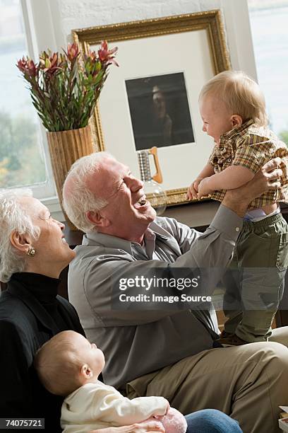 grandparents with babies - grandparents raising grandchildren stock pictures, royalty-free photos & images