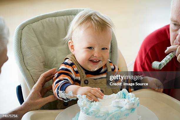 messy one year old with birthday cake - three year stock pictures, royalty-free photos & images