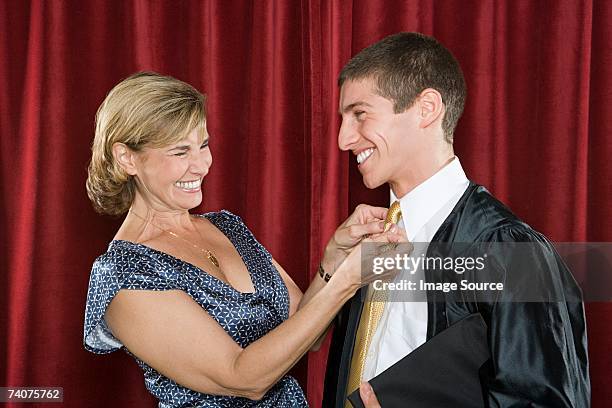 mother adjusting sons tie - ties stock pictures, royalty-free photos & images