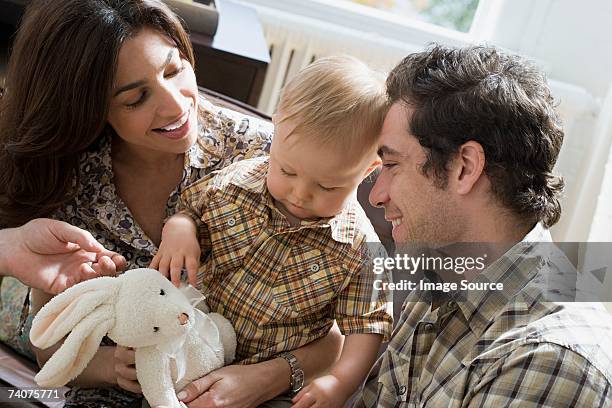 parents and little boy with soft toy - family rabbit stock pictures, royalty-free photos & images