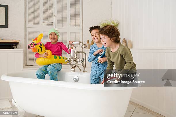 children playing in bath tub - boat in bath tub stock pictures, royalty-free photos & images