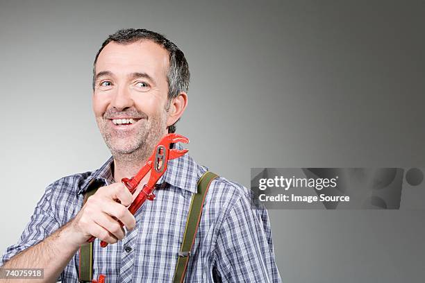 handyman with wrench - handyman smiling stock pictures, royalty-free photos & images