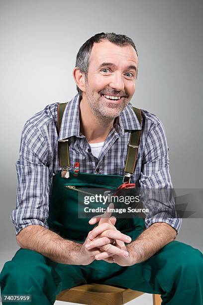 handyman smiling - handyman overalls stock pictures, royalty-free photos & images