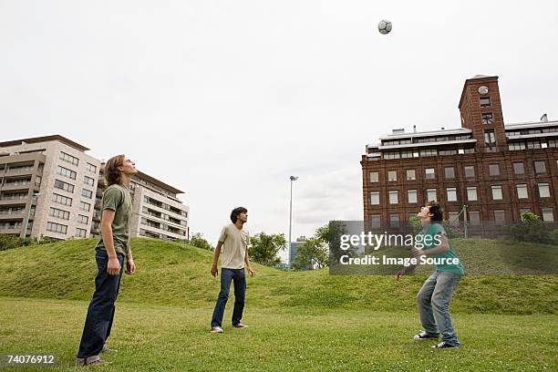 young men playing football - three storey stock pictures, royalty-free photos & images