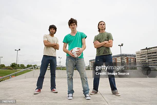 young men with football - three people standing stock pictures, royalty-free photos & images