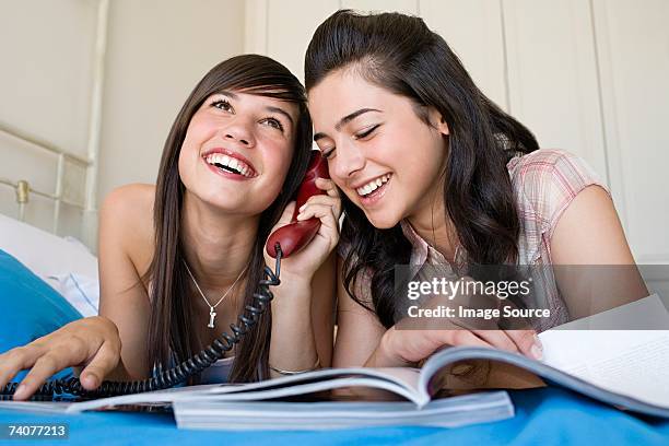 teenage girls using telephone - landline phone imagens e fotografias de stock