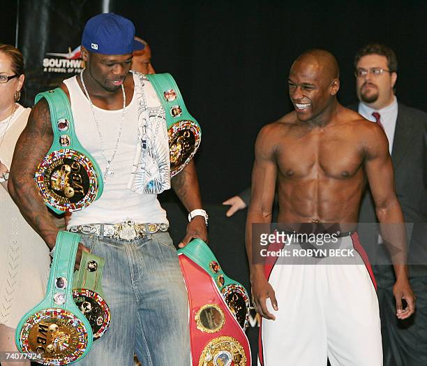 Las Vegas, UNITED STATES: Rapper 50 Cent holds Floyd Mayweather Jr.'s belts at the weigh-in 04 May 2007 at the MGM Grand Hotel Las Vegas, Nevada....