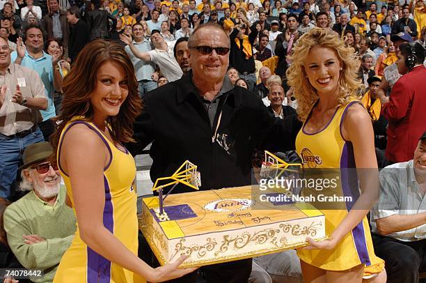 Members of the Laker Girls present a birthday cake to actor Jack Nicholson during the Los Angeles Lakers game against the Phoenix Suns in Game Three...