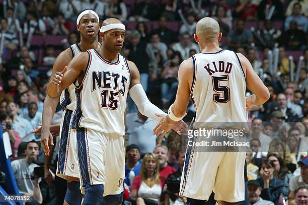 Jason Kidd and Vince Carter of the New Jersey Nets high five during a game against the Toronto Raptors in Game Six of the Eastern Conference...