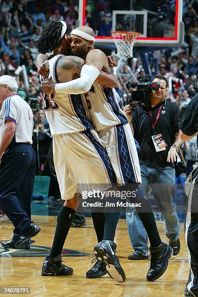 Vince Carter and Mikki Moore of the New Jersey Nets after defeating the Toronto Raptors by a score of 98-97 to win Game Six of and the Eastern...