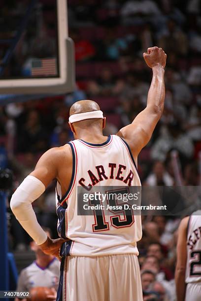 Vince Carter of the New Jersey Nets holds up his fist in celebration while playing against the Toronto Raptors in Game Six of the Eastern Conference...