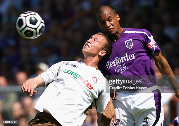 St. Pauli's Marcel Eger and Osnabrueck's Dominique Ndjeng jump for the ball during the Third League match between VFL Osnabrueck and FC St.Pauli at...